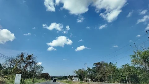 4K Camera video of highway road with clear blue sky during daytime Stock Footage 325720477