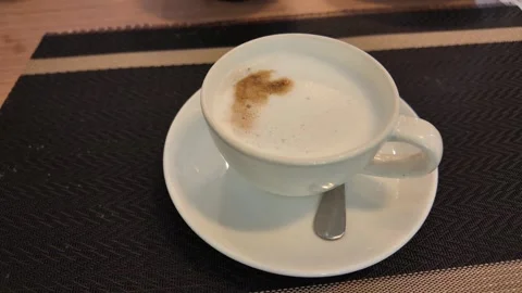4K Camera video of hot coffee cup on saucer in cafe setting Stock Footage 325720711