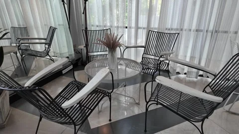 4K Camera video of modern lounge chairs and round glass table Stock Footage 325720448