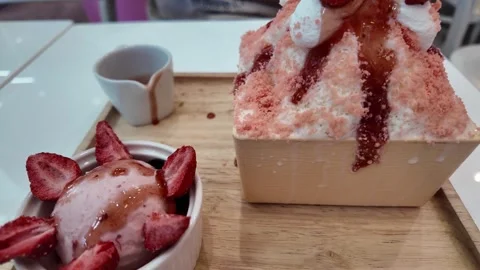 4K Camera video of strawberry bingsu Korean dessert served on wooden tray Stock Footage 325789955