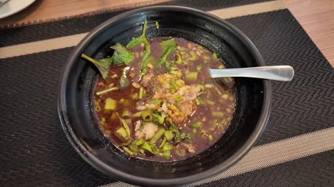 4K Camera video of Thai boat noodles served in black bowl Stock Footage 325720699