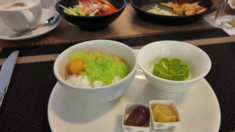 4K Camera video of Thai dessert in white bowls served on dining table Stock Footage 325720709