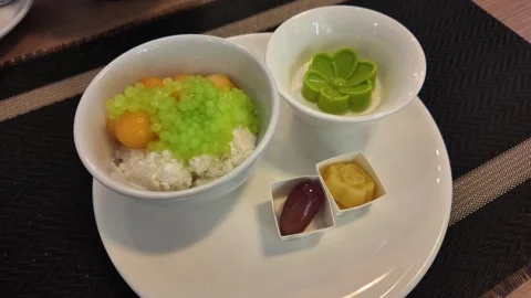 4K Camera video of Thai dessert in white bowls served on dining table Stock Footage 325720712