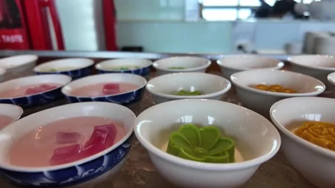 4K Camera video of Thai desserts served in small bowls on ice tray at buffet Stock Footage 325720658