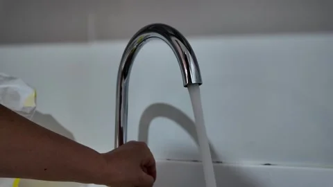 4K Camera video of water flowing from faucet into sink Stock Footage 325720522