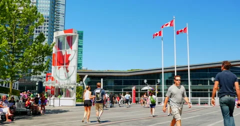 4K Canada Flags and Pedestrians Front of Vancouver Conference Center, BC, Canada Stock Footage 52140110