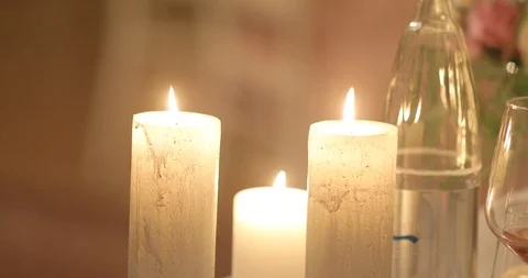 4k candles burning on dinner table with wine glasses cozy evening interior  Stock Footage 93337851