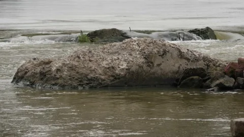 4k capture of a big rock in the middle of a running river Stock Footage 225739047