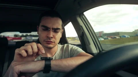 4K Car Driver Using His Smartwatch 스톡 동영상 67844064