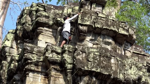 4K Caretaker clean the Ta Prohm temple. Staff man is working for maintenance-Dan Stock Footage 119060101