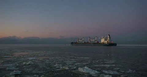 4K - A cargo ship sets out to sea on a frosty night Stock Footage 280875292