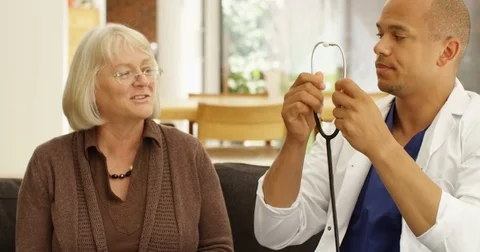 4K Caring community doctor examining senior lady in her home Stock Footage 81201768
