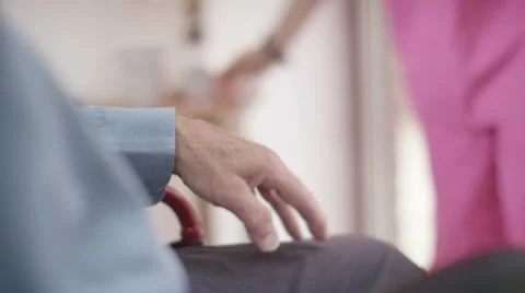 4K Caring home support nurse holding the hand of elderly man in wheelchair Stock Footage 56590229