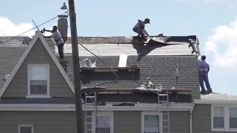 4K Carpenter workers apply new roof to old house, sound Stock-Footage 135550544