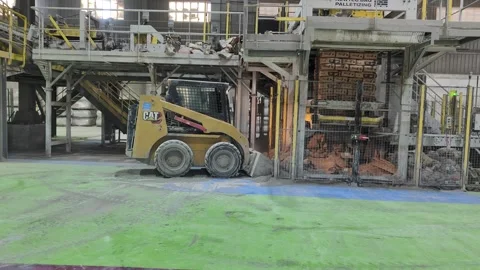 4K: CAT Skid Steer Loader Cleaning Debris in Cement Factory, Algeria Stock Footage 333245787