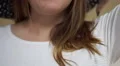 4K caucasian brunette woman ties black and white polkadot scarf around her neck 4k or 4k+ Resolution