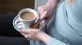 4k caucasian female hands dip gingerbread Christmas tree into tea 4k or 4k+ Resolution