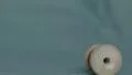 4K caucasian hand pushes red wooden thread roll, with green screen background 4k or 4k+ Resolution