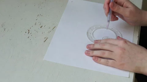 4k caucasian hands make spirograph shape with purple pen Stock Footage 61169923
