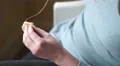 4K caucasian hands sewing peach felt together 4k or 4k+ Resolution
