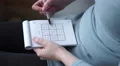 4k Caucasian hands solving a sudoku with biro pen 4k or 4k+ Resolution
