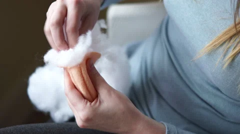 4K caucasian hands stuff felt ball with white stuffing Stock Footage 61297298