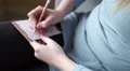 4K caucasian hands write shopping list with pencil and coloured paper 4k or 4k+ Resolution
