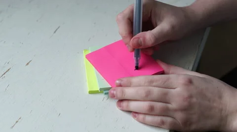 4K caucasian hands write wedding proposal on post it notes Stockbeeldmateriaal 61243540