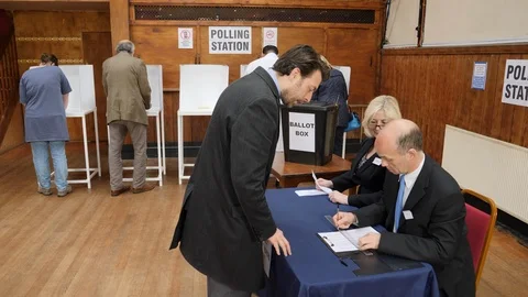4K: Caucasian Middle Aged Male Voter registering to vote at Polling Station Stock Footage