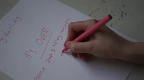 4K Caucasian person's hand writes note to desperate ex lover, it's OVER! Stock Footage 63130962