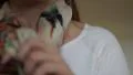 4K caucasian woman places beige patterned scarf on neck and rearranges hair 4k or 4k+ Resolution