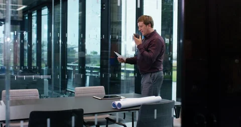 4K CEO alone in boardroom, making conference call on smartphone Stock Footage 118733753