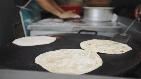 4k Chapati Indian bread making process turning on flat hot frying surface Stock Footage 107972864