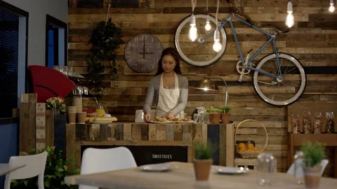 4K Cheerful cafe worker wiping down tables. Happy small business owner. Stock Footage 76604699