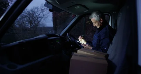 4K Cheerful delivery driver getting out of vehicle to make a delivery at dawn Stock-Footage 85581845