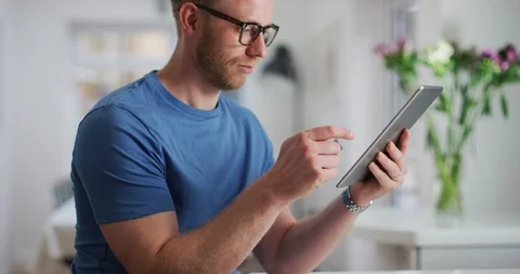 4K Cheerful man with computer tablet making electronic payment with credit card Stock Footage 108771252