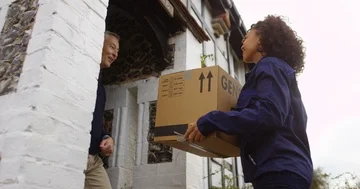 4K Cheerful man taking delivery of large box &amp; signing on electronic terminal. Stock Footage 85492697