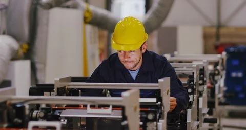 4K Cheerful servicing engineer checking industrial printing machines in factory Stock Footage 101995385