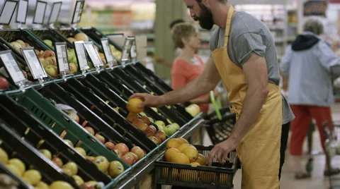 4K Cheerful worker in grocery store juggling oranges Stock Footage 64890329