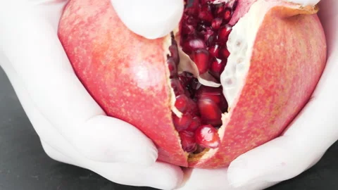 4K - Chef breaks an pomegranate in half. Close-up Stock Footage 165511004