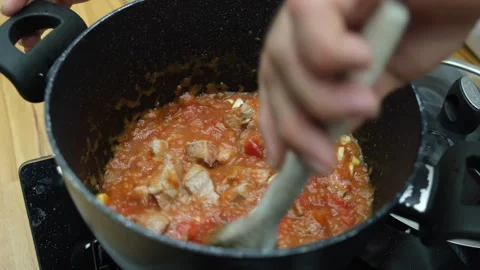 4k Chef cooking beef with tomato sauce on a hot pan Stock Footage 266386806