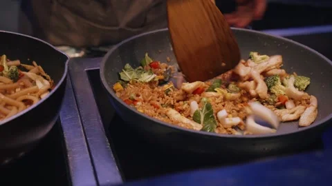 4K chef cooking chicken fried rice and udon noodles in pan and wok Stock Footage 316568346