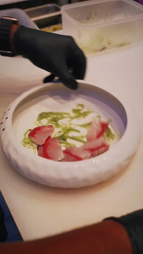 4K Chef preparing snapper sashimi with seaweed close up vertical video Stock Footage 315990422