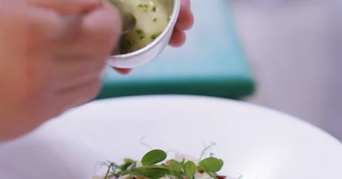 4k, Chef putting the final touches on a dinner plate in a professional kitchen. Stock Footage 62926125