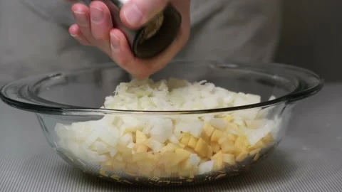 4K Chef sprinkles pepper on diced potatoes and onions.Preparation of the filling Stock Footage 166427229