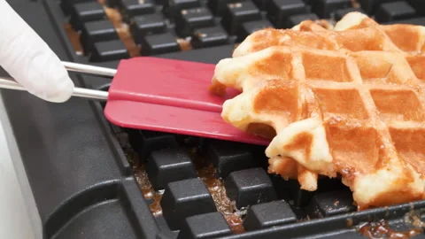 4K - Chef takes out the cooked waffle from the waffle iron. Close-up Stock Footage 166041994