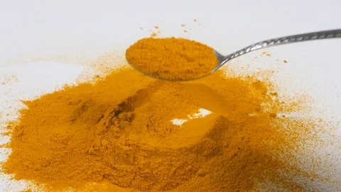 4K Chef Taking a teaspoon on Yellow Turmeric on pestle mortar on white surface Stock Footage 88478877
