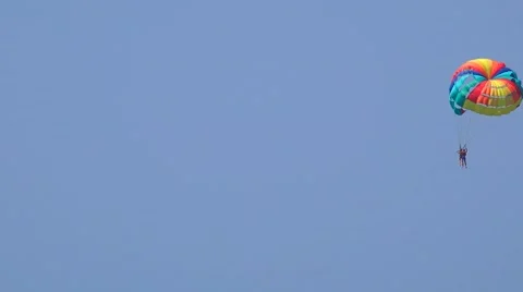 4k Child and instructor jumping with parachute over the blue sky background Stock Footage 55885459