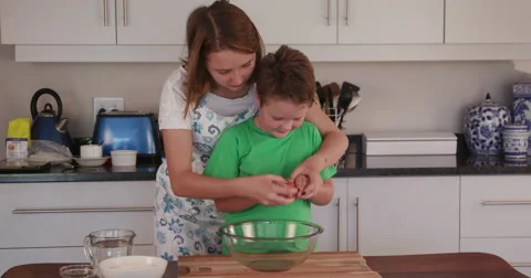 4K Children cracking an egg into bowl Stock Footage 64694733