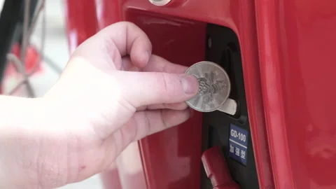4k. Childrens hand with allergies insert a token or coin into the slot to play Stock Footage 165650491